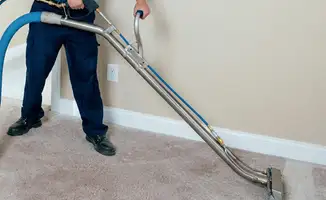 Professional operating a liquid removal machine on a carpeted floor in Chandler, AZ